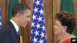 US President Barack Obama, left, shakes hands with Brazilian President Dilma Vana Rousseff, right, following their joint news conference at the Palacio do Planalto in Brasilia, Brazil, Saturday, March 19, 2011. "