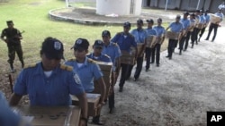 Police officers carry boxes filled with ballots to waiting vehicles that will distribute the material to polling centers, in Managua, Nicaragua, November 5, 2011.