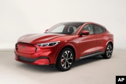 FILE - In this Wednesday, Oct. 30, 2019 photo, the new Ford Mustang Mach-E SUV is shown in Warren, Michigan. Americans will have a tax credit of $4,000 to buy a used electric vehicle and up to $7,500 for a new one. (AP Photo/Carlos Osorio)