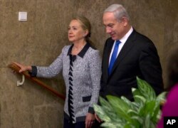 FILE - Israel's Prime Minister Benjamin Netanyahu walks with U.S. Secretary of State Hillary Rodham Clinton upon her arrival to their meeting in Jerusalem, Nov. 20, 2012.