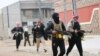 Tribal fighters aligned with government forces are seen patrolling the streets in the city of Fallujah, 50 km west of Baghdad, Jan. 5, 2014.