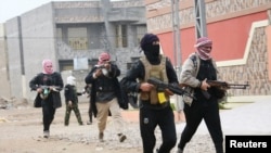 Tribal fighters aligned with government forces are seen patrolling the streets in the city of Falluja, 50 km west of Baghdad Jan. 5, 2014.