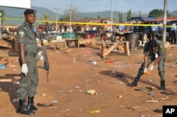 Police collect items at the site of a bomb explosion in Nyanya outskirt of Abuja, Nigeria, Oct. 3, 2015.