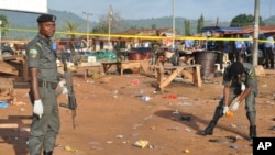 FILE - Police collect items at the site of a bomb explosion on the outskirts of Abuja, Nigeria, Oct. 3, 2015. 