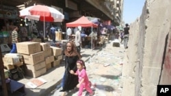 A child cries as she runs with her mother following a nearby double suicide bombing in Baghdad, 5 Sept 2010