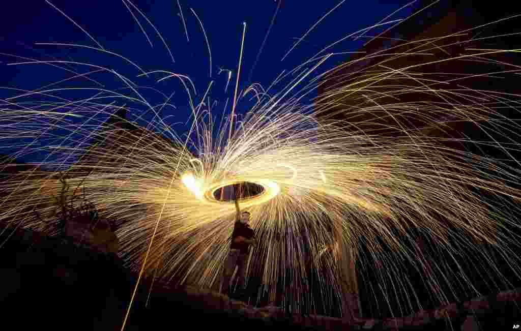 Palestinians light fireworks to celebrate the holy month of Ramadan in Gaza City, May 13, 2019.