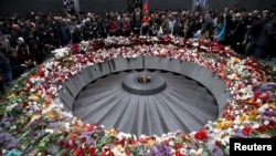 File - People attend a commemoration ceremony to mark the centenary of the mass killing of Armenians by Ottoman Turks at the Tsitsernakaberd Memorial Complex in Yerevan, Armenia, April 2015.