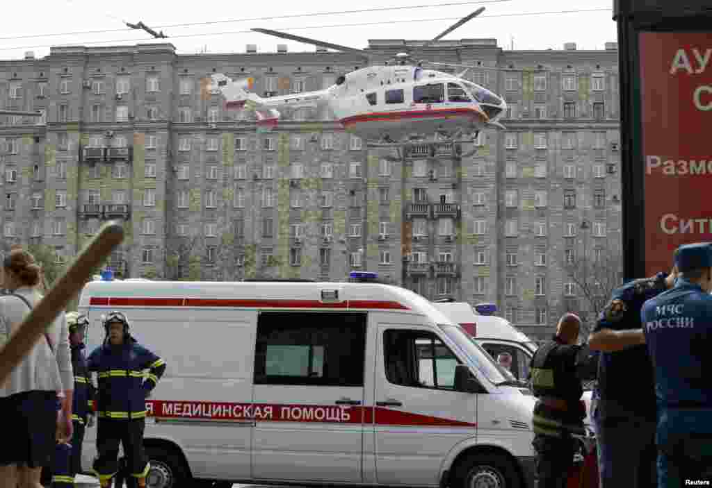 An emergency service helicopter lands outside a metro station following an accident on the subway in Moscow, July 15, 2014.