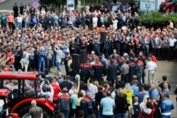 Workers gather during a rally at the Minsk Tractor Works Plant in Minsk, Belarus, Aug. 14, 2020.