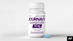 This photo provided by Vertex Pharmaceuticals in January 2025 shows a tablet and bottle of the JOURNAVX (suzetrigine) medication. 