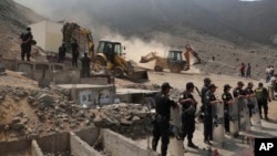 Peruvian authorities demolish a Shining Path mausoleum in a cemetery on the outskirts of Lima, Peru, Dec. 29, 2018. 