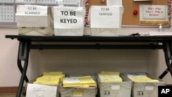 FILE - Ballots await further processing at the Franklin County Board of Elections in Columbus, Ohio, Dec. 14, 2017. The Supreme Court’s decision upholding Ohio’s method of removing people from voter rolls appears unlikely to have a ripple effect. Ohio followed the most aggressive path among states that have laws targeting inactive voters.