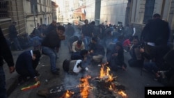 Demonstrators lay down while facing members of Bolivia's military as Bolivia's President Luis Arce "denounced the irregular mobilization" of some units of the country's army in La Paz, Bolivia, June 26, 2024. 