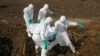 FILE - Health workers carry the body of a suspected Ebola victim for burial at a cemetery in Freetown, Sierra Leone, Dec. 21, 2014. 