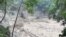 An image taken from video on Oct. 5, 2023, shows a damaged steel bridge over the flooded Teesta River in north Sikkim's Chungthang region of India. The death toll from a glacial lake burst that triggered a torrential flash flood has risen to at least 47 people. (Indian Army/AFP)