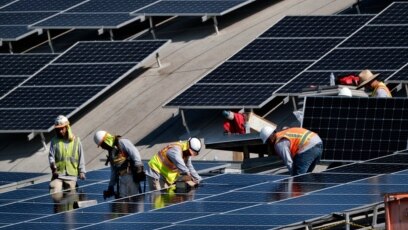 Công nhân lắp đặt tấm pin mặt trời ở Sân bay Van Nuys ở Los Angeles, California, hôm 8/8/2019. Bộ Thương mại Mỹ vừa trì hoãn quyết định điều tra có thể dẫn tới áp thuế lên pin mặt trời nhập từ Việt Nam và 2 quốc gia châu Á khác.