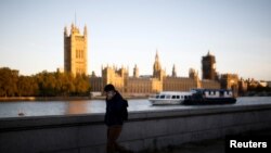 FILE - The sun rises over the Houses of Parliament in London, Britain, Sept. 10, 2020. 