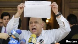 Jesus Torrealba, secretary of Venezuela's coalition of opposition parties (MUD), shows a copy of the form to collect signatures to begin the process of seeking a referendum to remove President Nicolas Maduro during a news conference in Caracas, Venezuela,