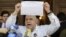 Jesus Torrealba, secretary of Venezuela's coalition of opposition parties (MUD), shows a copy of the form to collect signatures to begin the process of seeking a referendum to remove President Nicolas Maduro during a news conference in Caracas, Venezuela,