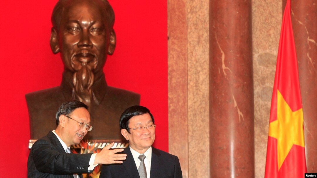 China's State Councillor Yang Jiechi, left, stands with Vietnam's President Truong Tan Sang in front of a bust of the late Vietnamese revolutionary leader Ho Chi Minh, at the Presidential Palace in Hanoi, Oct. 27, 2014.