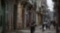 FILE - People walk on a street in Havana, Cuba, April 10, 2019. 