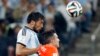 Argentina's Ezequiel Garay, left, and Netherlands' Robin van Persie go for a header during their World Cup semifinal soccer match at Itaquerao Stadium in Sao Paulo, July 9, 2014.