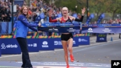 Shalane Flanagan crosses the finish line first in the women's division of the New York City Marathon in New York, Nov. 5, 2017.
