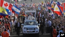 Pope Francis waves from his popemobile as he arrives to celebrate an early morning Mass at the metro park Campo San Juan Pablo II in Panama City, Jan. 27, 2019. 