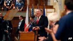 FILE - U.S. Secretary of State Mike Pompeo, center, smiles as he arrives for a meeting of the senate in Prague, Czech Republic, Aug. 12, 2020. 