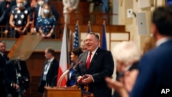 FILE - U.S. Secretary of State Mike Pompeo, center, smiles as he arrives for a meeting of the senate in Prague, Czech Republic, Aug. 12, 2020. 