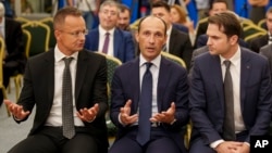 From left, Hungarian Foreign Minister Peter Szijjarto, Georgian Minister of Economy Levan Davitashvili and Romanian Energy Minister Sebastian Burduja meet in Bucharest, Romania, on Sept. 3, 2024, to discuss a power line project under the Black Sea.