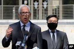 FILE - Attorney David Sanford, left, standing with Young Lee, right, brother of murder victim Hae Min Lee, talks with reporters outside Maryland's Supreme Court in Annapolis, Oct. 5, 2023.