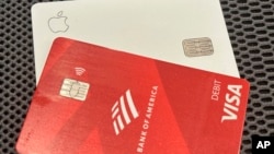 FILE - A Visa debit card and Apple credit card in a photo taken in New York on Sept. 24, 2024. The U.S. Department of Justice accuses Visa of stifling competition in the debit card market.