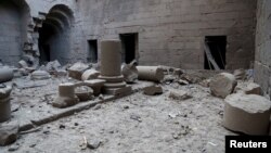 Damaged pillars lie on the ground in a square in Bosra's ancient citadel after what activists said was an airstrike by forces loyal to Syria's president Bashar al-Assad, in the town of Bosra al-Sham, Deraa, Dec. 23, 2015.