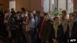 (FILE) Children gather in a school during their evacuation to western Ukraine, from the southern city of Kherson amid the Russian invasion of Ukraine.
