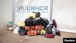 资料照片：阿富汗赫拉特省伊斯兰卡拉边境口岸附近一处遣返移民营地，联合国难民署帐篷旁堆放着被伊朗驱逐的阿富汗公民的行李。(2025年7月22日)