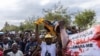 People shout slogans and protest during the funeral and burial of Elvino Dias, the lawyer for the presidential candidate of the opposition Party Optimist for the Development of Mozambique (PODEMOS) Venancio Mondlane, at a church in Michafutene, near Maput