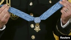 FILE - The Medal of Honor is seen before presentation in the East Room of the White House in Washington Nov. 12, 2015. A Navy SEAL who helped rescue an American hostage in Afghanistan will be the nation's next Medal of Honor recipient, the White House announced on Tuesday.