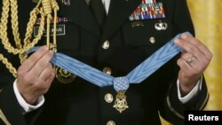 FILE - The Medal of Honor is seen before presentation in the East Room of the White House in Washington Nov. 12, 2015.