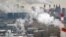 FILE - An aerial view of Moscow, with steam and smoke rising cooling towers and chimneys of a coal-fired power plant in the foreground.
