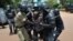 FILE - Critics say enforcement tactics by Uganda police are dictated by the government and are intended to intimidate the opposition. On March 28, 2012, police detained a supporter of opposition leader Kizza Besigye.
