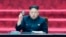 FILE - North Korean leader Kim Jong Un holds up a parliament membership certificate during the Supreme People's Assembly in Pyongyang, North Korea, April 9, 2014.