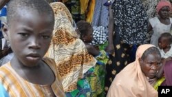 An Indian policeman fires a teargas shell towards demonstrators during a protest against the recent killings in Kashmir, in Srinagar.