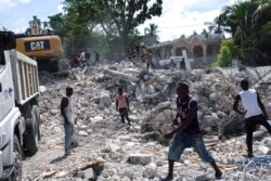 People remove debris at the collapsed Le Manguier hotel in Les Cayes, Haiti, Aug. 16, 2021, two days after a 7.2-magnitude earthquake struck the southwestern part of the country.