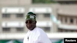 FILE — Nigeria's President Bola Tinubu looks on after his swearing-in ceremony in Abuja, May 29, 2023.