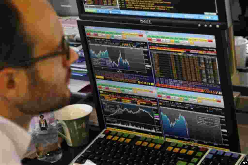 A stock trader looks at a graph displaying activity on the French Stock Exchange, in Paris, Wednesday, Aug. 17, 2011. The leaders of France and Germany called Tuesday for greater economic discipline and unity among European nations but declined to take im