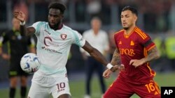 Salernitana's Boulaye Dia, left, and Roma's Leandro Paredes vie for the ball during the Serie A soccer match between Roma and Salernitana, at Rome's Olympic Stadium, Sunday, Aug. 20, 2023.