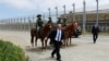 FILE - Former Immigration and Customs Enforcement (ICE) Deputy Director Thomas D. Homan walks to his vehicle after greeting U.S. border patrol agents on horseback during a visit to the U.S.-Mexico border wall near San Diego, California, May 7, 2018. 