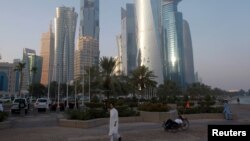 FILE - A man walks on the corniche in Doha, Qatar, June 15, 2017.