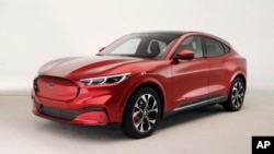 In this Wednesday, Oct. 30, 2019 photo, the new Ford Mustang Mach-E SUV is shown in Warren, Mich. Ford is hoping to sell the new electric SUV for daily drivers that looks like a Mustang performance car. (AP Photo/Carlos Osorio)